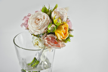 A small bouquet of flowers on a white background. Wedding bouquet for the groom.