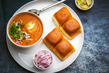 Indian spicy fast food / snacks Paav Bhaji with bread, onion and butter