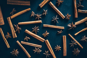 Star anise and cinnamon on dark background. Christmas spices background.