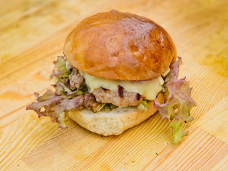 Fresh hamburger on natural wooden background.