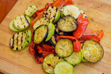 Grilled vegetables on a wooden board. Close up.