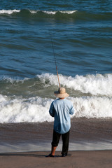Nha Trang Vietnam, silhouette of man fishing from beach in the late afternoon