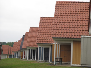 Perspective view of identical wooden holiday homes