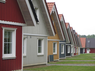 Perspective view of identical wooden holiday homes