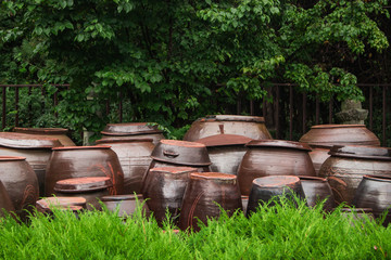 Fototapeta premium Onggi(Korean earthenware) outside house. Onggi is used as food containers, and also it has a microporous structure to assist in the fermentation in food processing such as the preparation of kimchi.