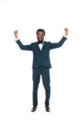 happy african american bridegroom gesturing while celebrating isolated on white