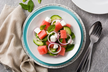 Watermelon salad with feta cheese on gray background