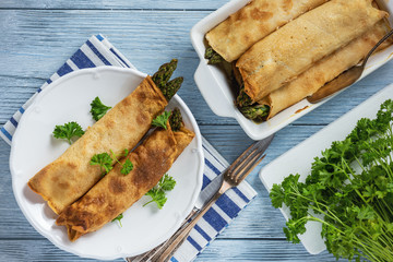 Asparagus and ham stuffed pancakes, baked on oven.
