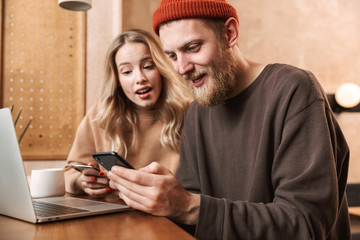 Happy young couple spending time at the cafe