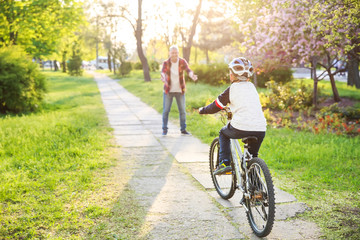 Father teaching his son to ride bicycle outdoors