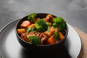 Traditional homemade Hungarian beef meat stew, Goulash with potatoes, carrots , tomatoes, broccoli in a bowl