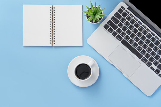 Business concept, relaxation in working time, drinking coffee taking a break on clean light blue office table, copy space, flat lay, top view, mockup