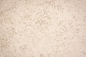 Eine helle Steinmauer mit schöner Struktur als Hintergrund