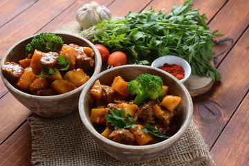 Traditional homemade Hungarian beef meat stew, Goulash with potatoes, carrots , tomatoes, broccoli in a bowl