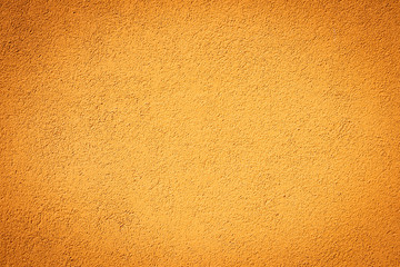 Eine orange Steinmauer mit Vignette als Hintergrund
