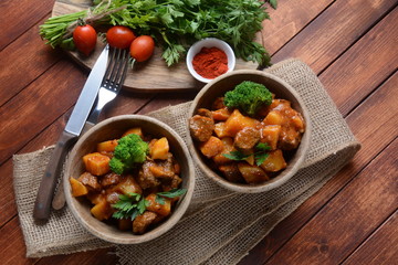 Traditional homemade Hungarian beef meat stew, Goulash with potatoes, carrots , tomatoes, broccoli in a bowl