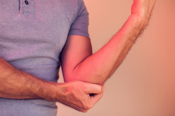 Man feels pain in elbow. People, healthcare and medicine concept