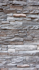 Texture of wall build from stone slabs and bricks stacked on top of each other.
