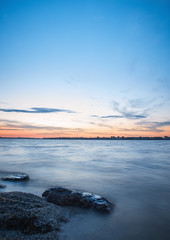 early sunrise on the beach with the stone in focus