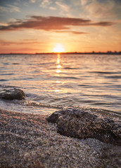 sunrise on the beach with the stone in focus