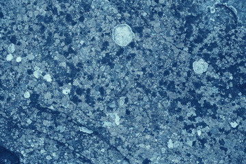 Vintage blue background. Rough painted wall of sapphire color. Imperfect plane of blue colored. Uneven old decorative toned backdrop of cyan tint. Texture of sapphirine hue. Ornamental stony surface.