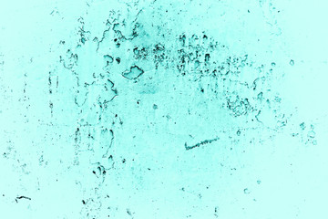 Vintage azure background. Rough painted wall of turquoise color. Imperfect plane of cyan colored. Uneven old decorative toned backdrop of aqzure tint. Texture of teal hue. Ornamental stony surface.