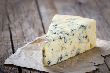 Blue cheese on wooden rustic table.