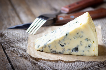 Blue cheese on wooden rustic table.