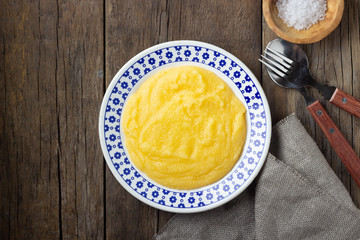 Italian food polenta on wooden table. Top view.