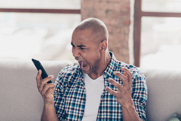 Portrait of disappointed hipster people hold hand have rest free time crazy shout have misunderstanding wear plaid checked shirt room