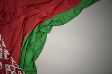waving national flag of belarus on a gray background.