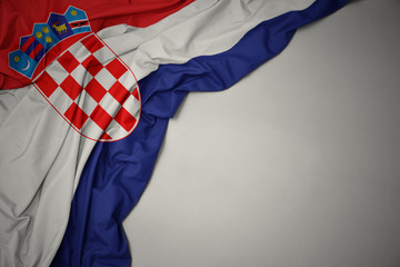 waving national flag of croatia on a gray background.