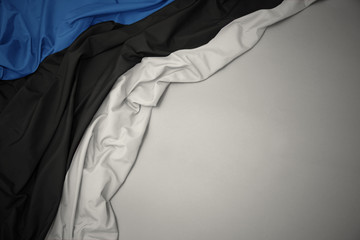 waving national flag of estonia on a gray background.