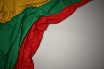 waving national flag of lithuania on a gray background. - obrazy, fototapety, plakaty