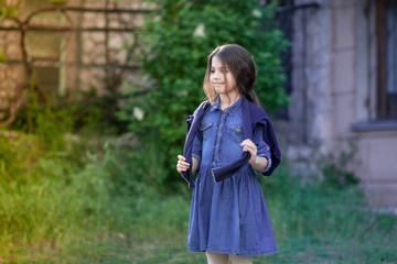 Little girl walking and looking on smth.