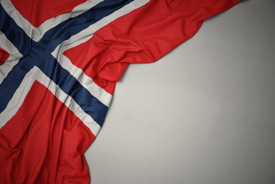 waving national flag of norway on a gray background.