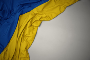 waving national flag of ukraine on a gray background.