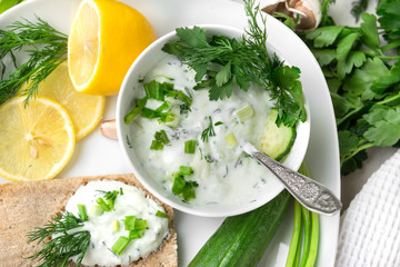 plate of Greek yogurt with herbs , cucumber and lemon