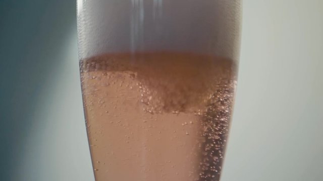 rose sparkling wine champagner reverse pour in slow motion.
