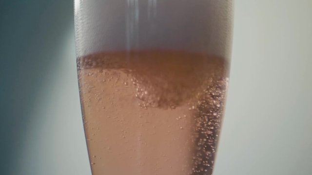 reverse pour in champagne sparkling wine rose super slow motion.
