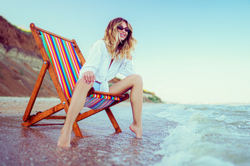 Pretty woman relaxing on a lounger beach. summer vacation concept. Copyspace