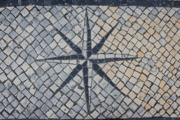  Street mosaic, stone pavement with wind rose background. Sidewalk design