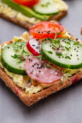 Sandwiches with cream cheese, vegetables and salami.