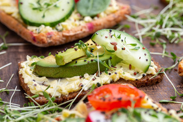 Sandwiches with cream cheese, vegetables and salami.