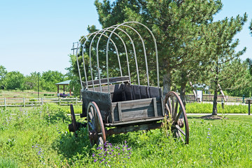 An old wagon sits in the middle of a field in Nebraska.