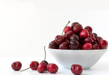 Сherries in the plate. Food background. White background. Fruits cherries on white background.