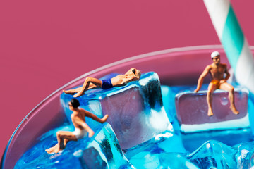 miniature men in swimsuit on a cocktail