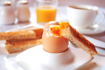 Brakfast table with soft boiled egg. Selective focus