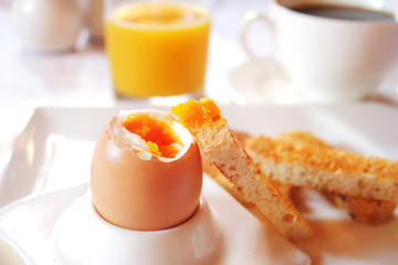 Brakfast table with soft boiled egg. Selective focus