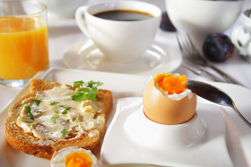 Fototapeta premium Brakfast table with soft boiled egg. Selective focus